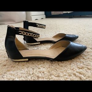 Black flats with gold chain detailing